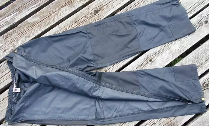 A pair of hiking pants on a wooden floor