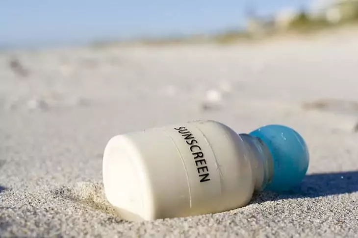 abandoned sunscreen on the beach