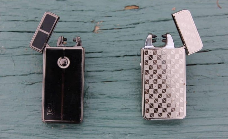 Two arc lighters on a wooden table