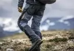Man wearing a pair of rain hiking pants climbing the mountains
