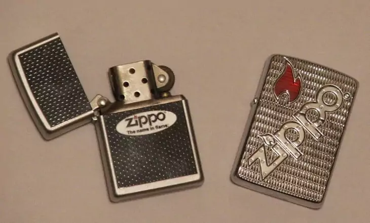 Two Zippo lighters on a table