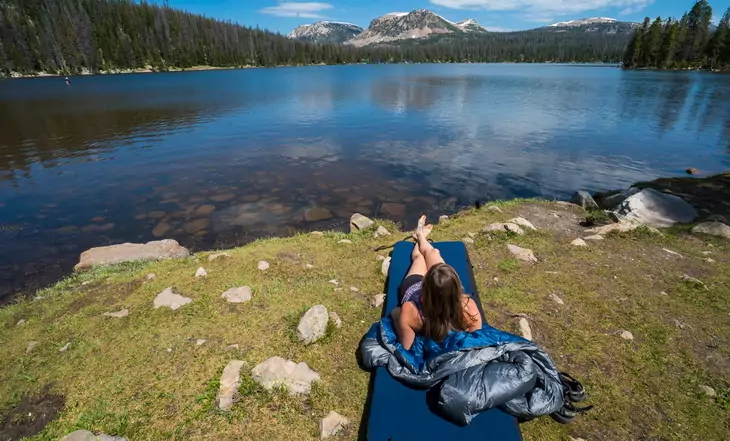 Woman sitting on a Therm-a-rest DreamTime Sleeping Pad