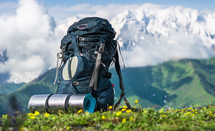 Tourist backpack and sleeping pad on a background of mountains, Georgia (Svaneti)
