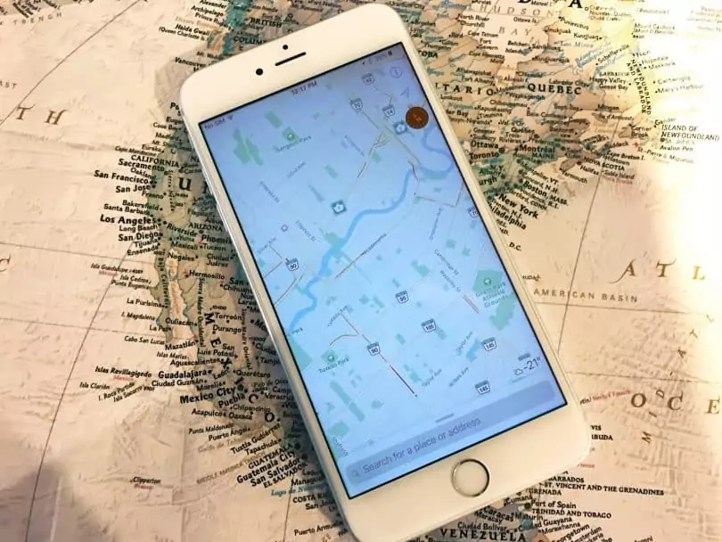 an iphone sitting on a map
