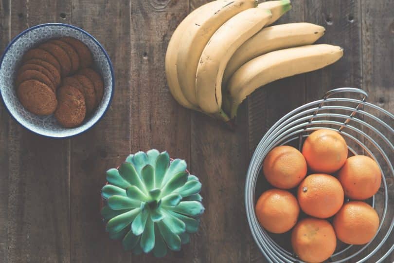 a picture of a yellow bananas beside oranges