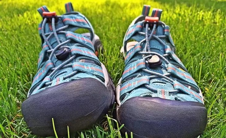 A pair of sport sandals for hiking on the grass