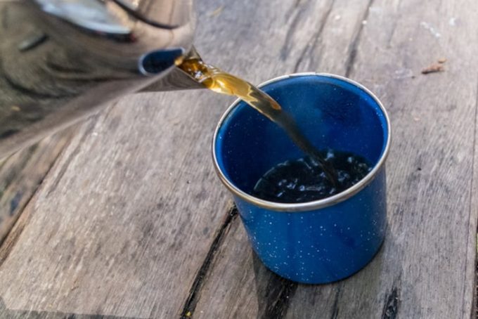 Image showing the cup of a camping thermos on a table