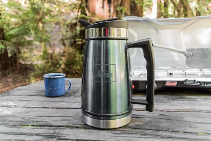 Image showing a camping thermos on a wooden table in the garden