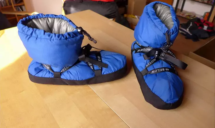 A pair of blue camping booties on the table