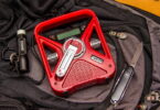 Image of Eton FRX3 Smartphone Charger and Radio, a Flashlight and a Knife on a backpack