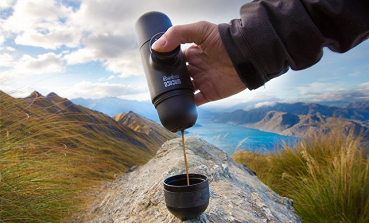 A person pouring coffe from the MiniPresso-GR-Espresso-Maker