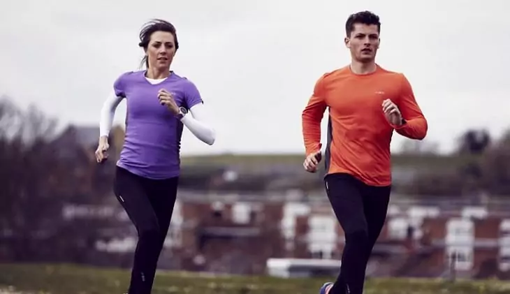 Two adults running wearing two base layers