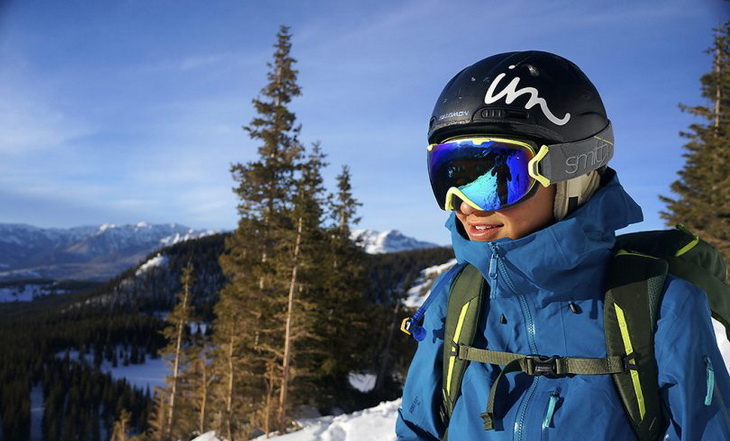 Woman wearing a hardshell jacket while skiing