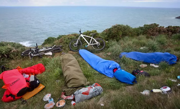 Bivy sacks and a couple of bikes and an ocean landscape