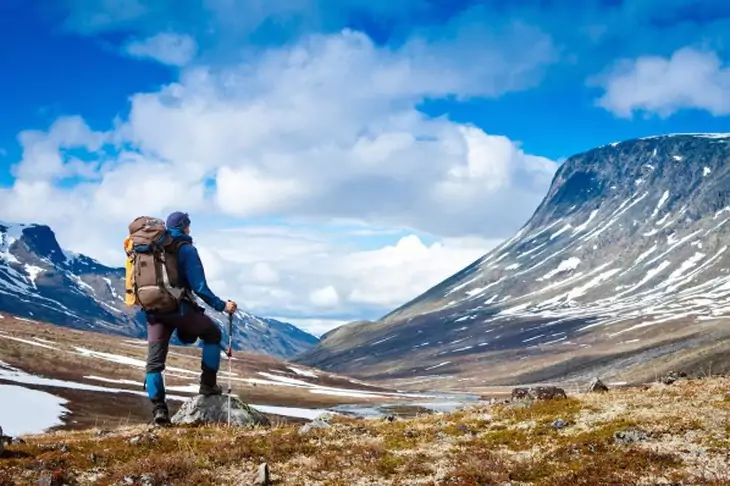 Hiker in the mountains watching the landscape