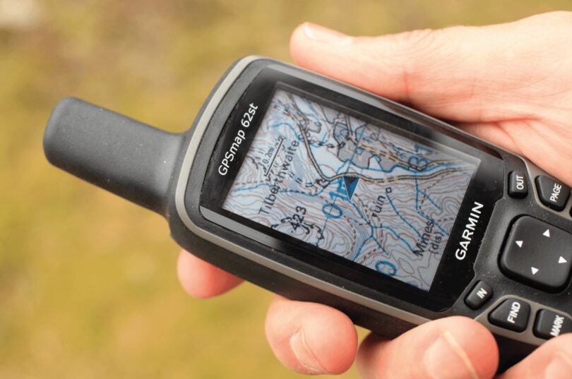 picture of a man holding a hiking GPS