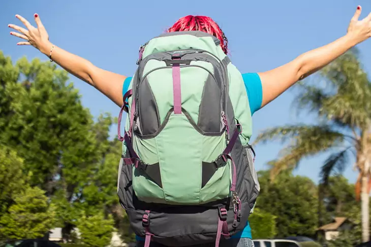 picture of a young woman carrying travel-backpacks