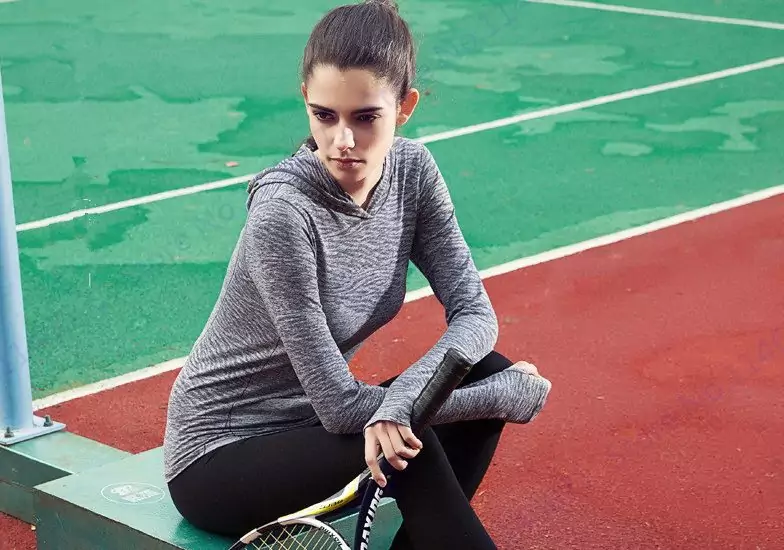 woman playing tennis in base layer clothing