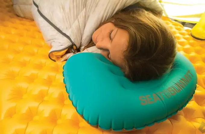 woman sleeping on inflatable pillow