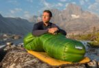 person sitting in a Western Mountaineering sleeping bag