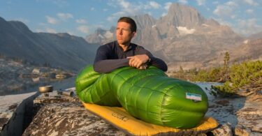 person sitting in a Western Mountaineering sleeping bag
