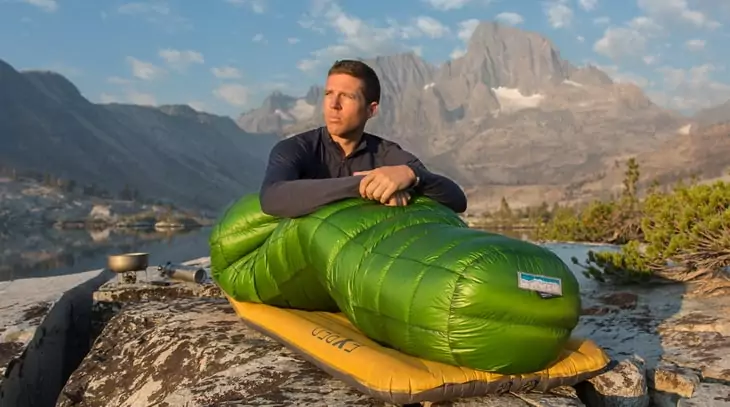 person sitting in a Western Mountaineering sleeping bag