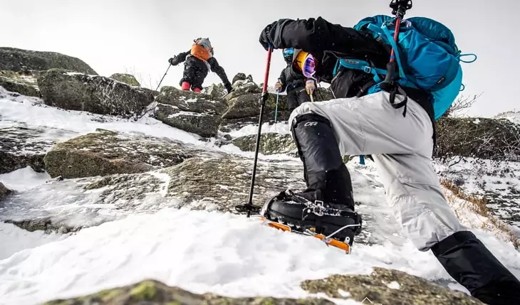 Backpackers climbing the mountains wearing Mountaineering Boots