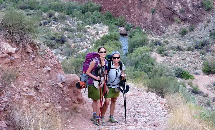 Two womens wearing hiking skirts are looking at the camera for a picture