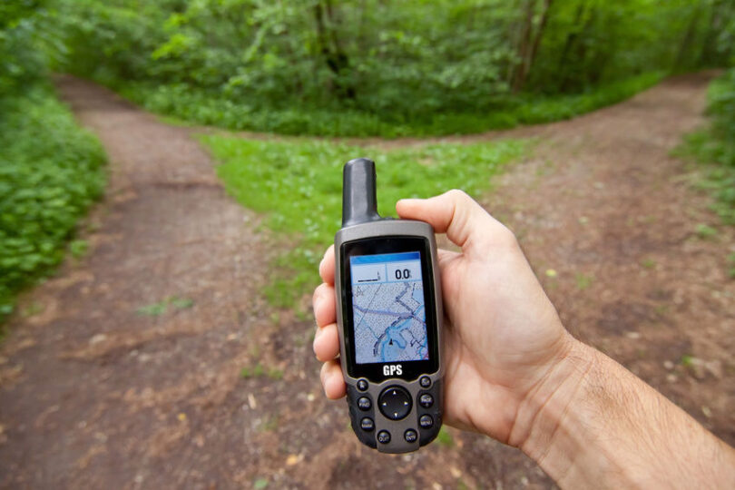 Image of a man holding a Garmin GPS in his hands