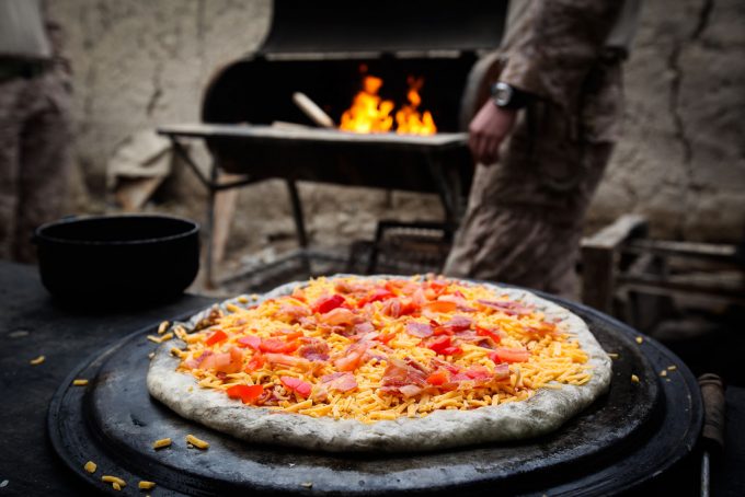 pizza preparing to be cooked on grill