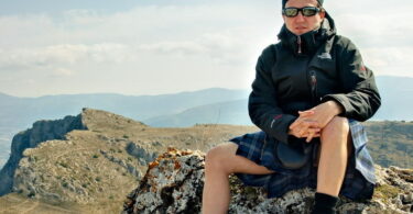 A man in kilt enjoying the nature around him