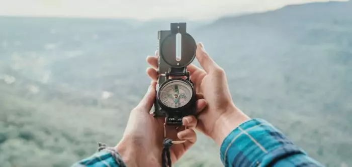Image showing a person holding a compass for hiking