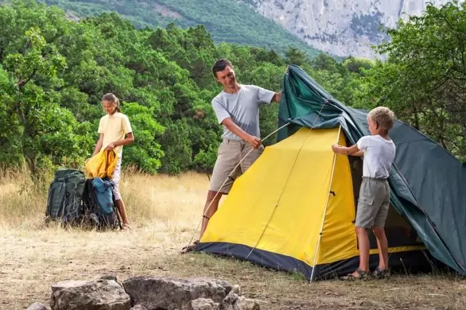 Image showing a father and his kid -setting-up-a-tent