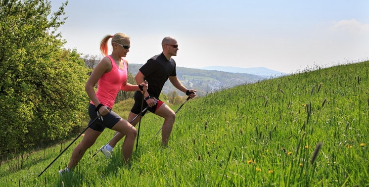 two persons climbing the hill