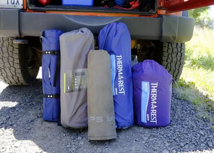 picture of camping pads near a sport car