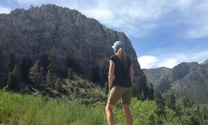 Woman in shorts watching the mountain in front of her