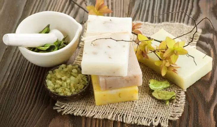 Handmade Soap with natural ingredients over wooden background