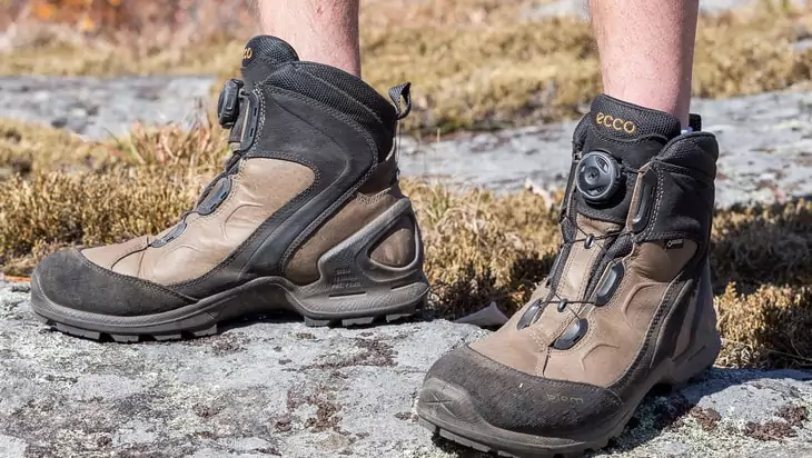 Man wearing a pair of ECCO-Mens-BIOM-Terrain-Mid-GTX-hiking-boot