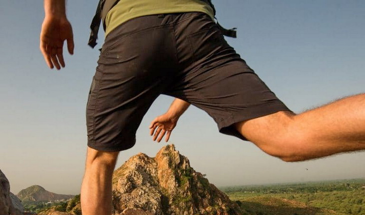 Image of a man jumping while wearing a pair of hiking shorts