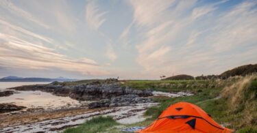 Orange Camping Tent Near Body of Water during Daytime