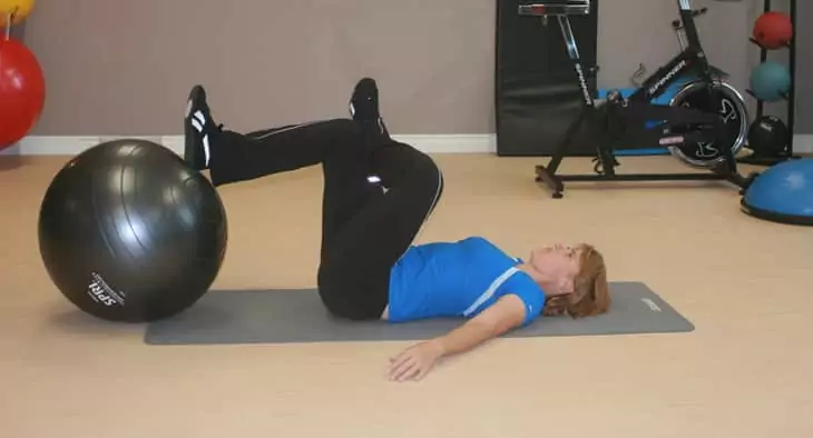 Woman doing Figure-4 stretch exercise