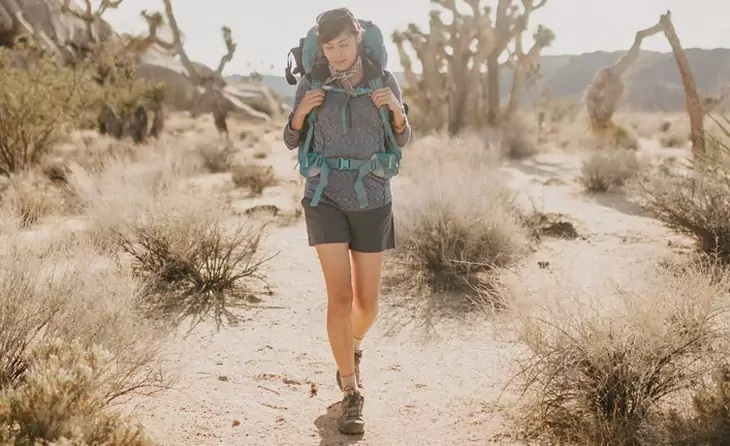 Image showina a woman wearing a backpack while hiking