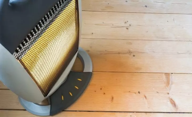 Image of a tent heater on a wooden floor