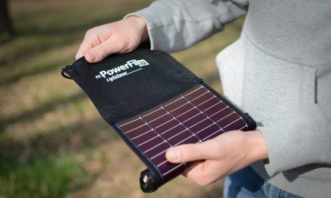 The-LightSaver-portable-solar-charger in a man's hands