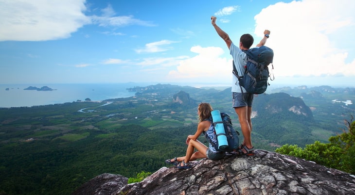 two adults on top of mountains