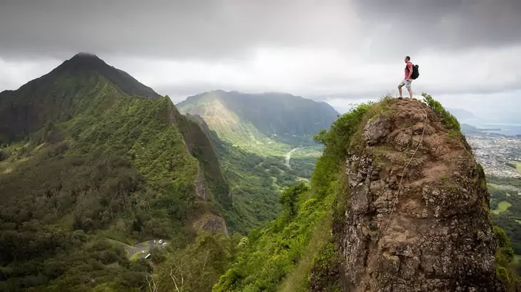 Man on top of the mountains watching the landscape