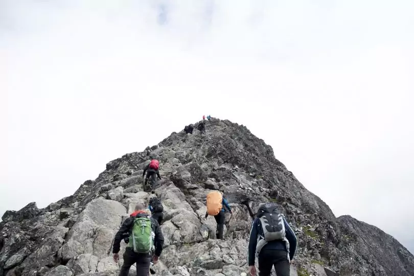 backpakers climbing a mountain