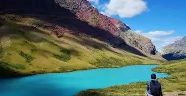 Hiker standing near a glaciar lake in America