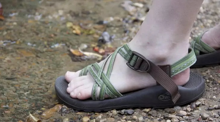 Image of a woman wearing a pair of hiking sandals in the summer