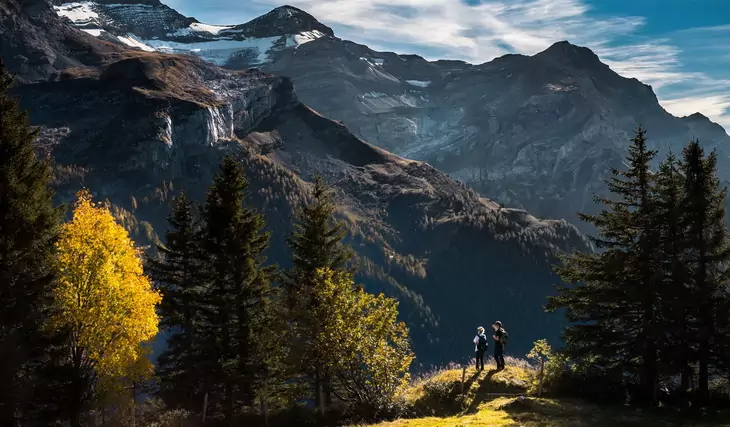 two adults watching the mountains landscape